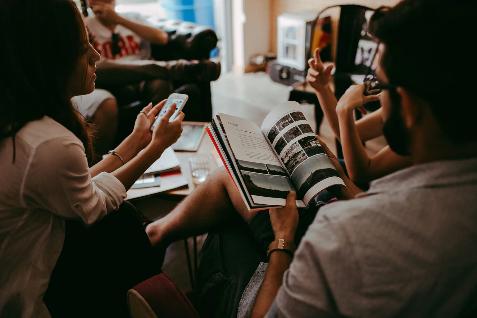 Adults reading and discussing a magazine together